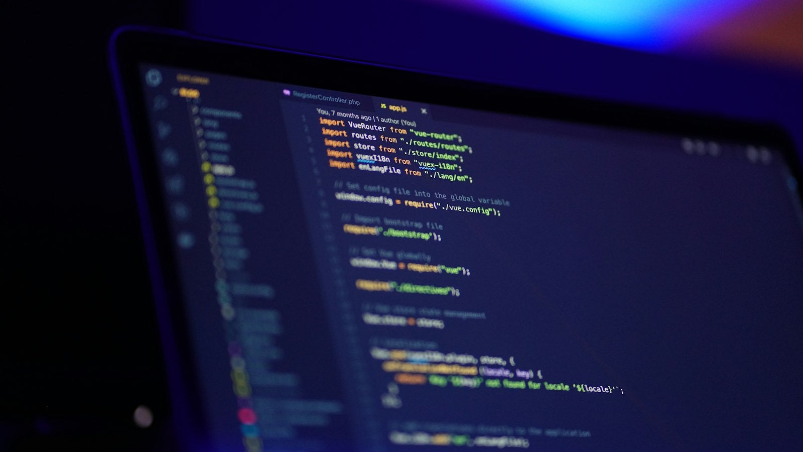 A laptop screen displaying colorful application code
